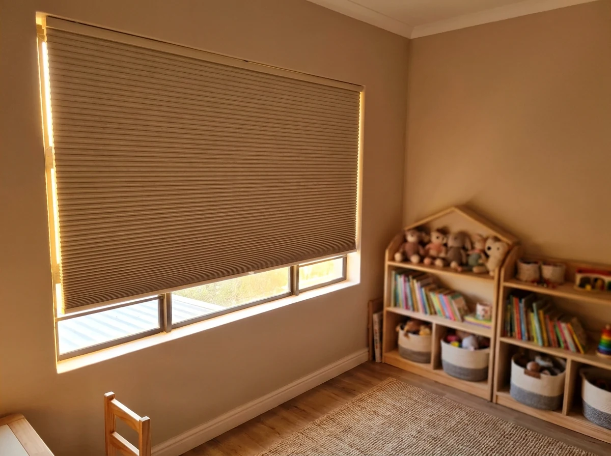 Double-cell honeycomb blockout blind lowered over a west-facing kid's-room window in a Ruimsig family home